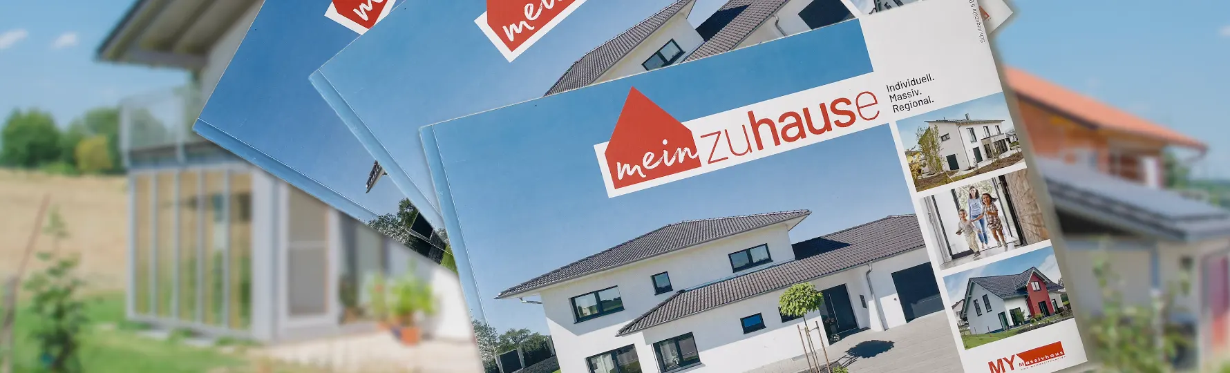 Titelblatt mehrerer Hausbau-Broschüren mit dem Titel 'mein Zuhause' vor einem unscharfen Hintergrund eines modernen Einfamilienhauses mit Wintergarten.